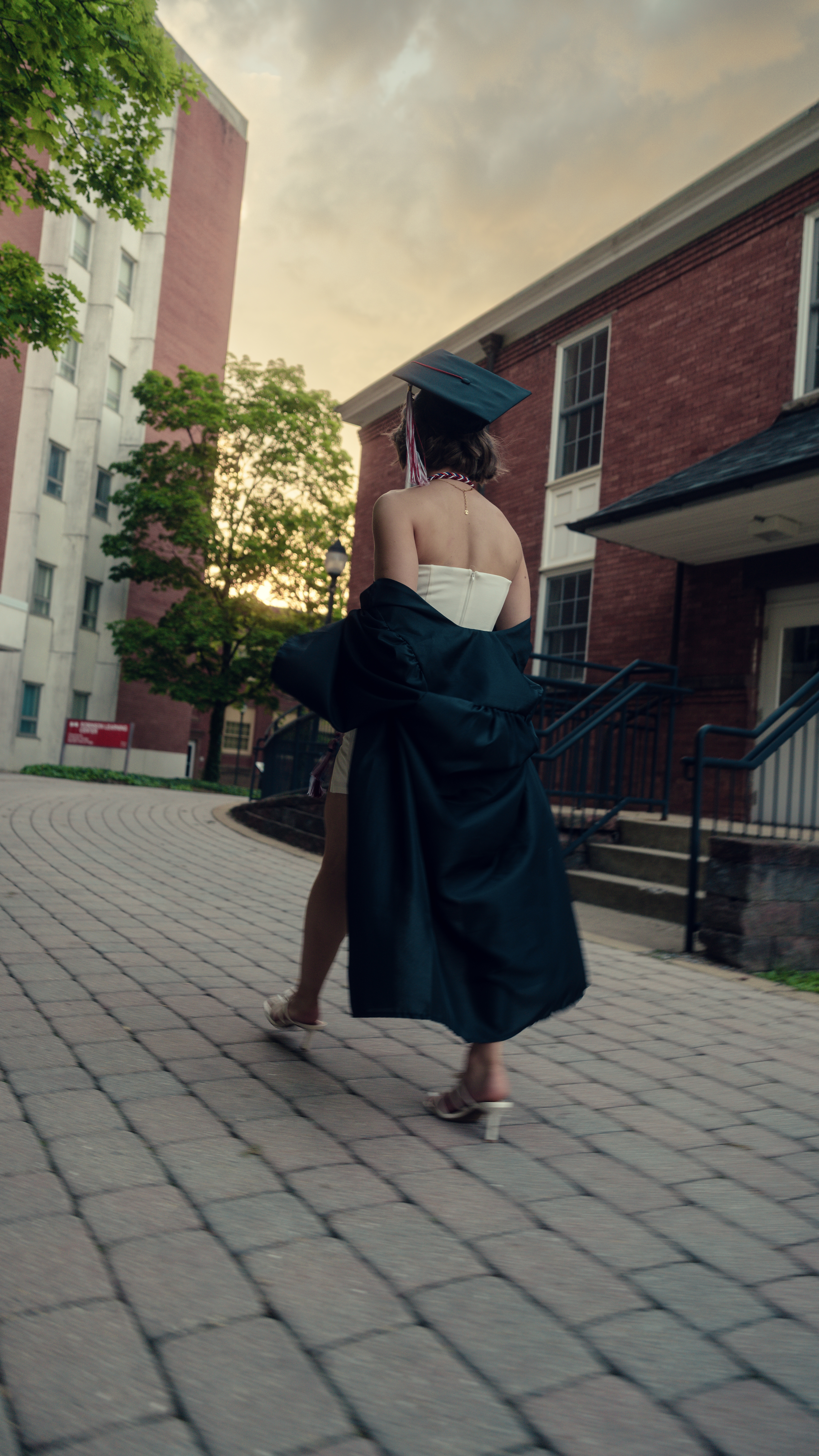 Graduate walking at golden hour