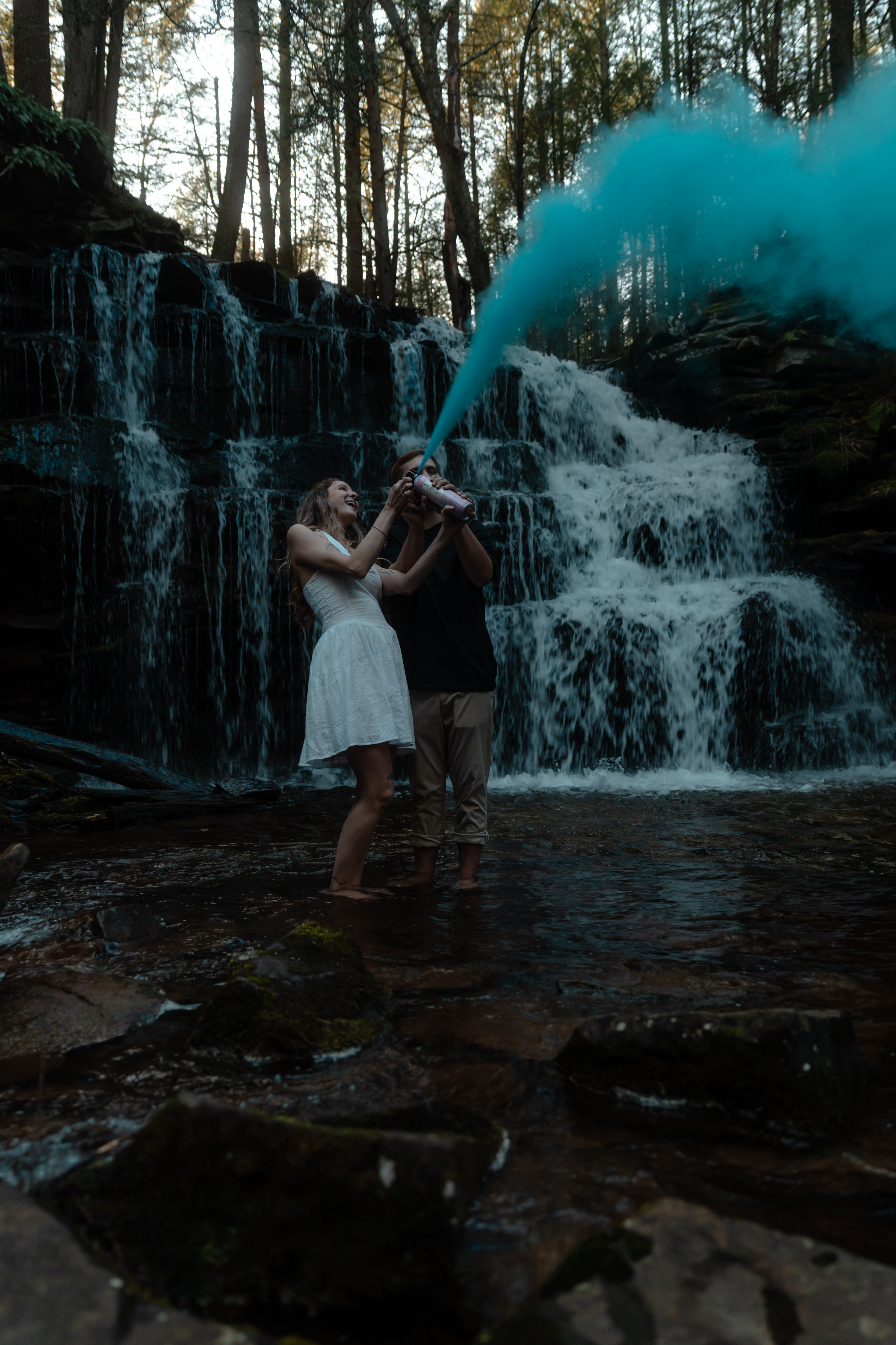 Couple at waterfall with smoke